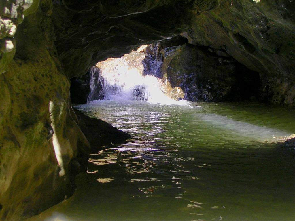Visitors walking through the shallow water at Gucchu Pani